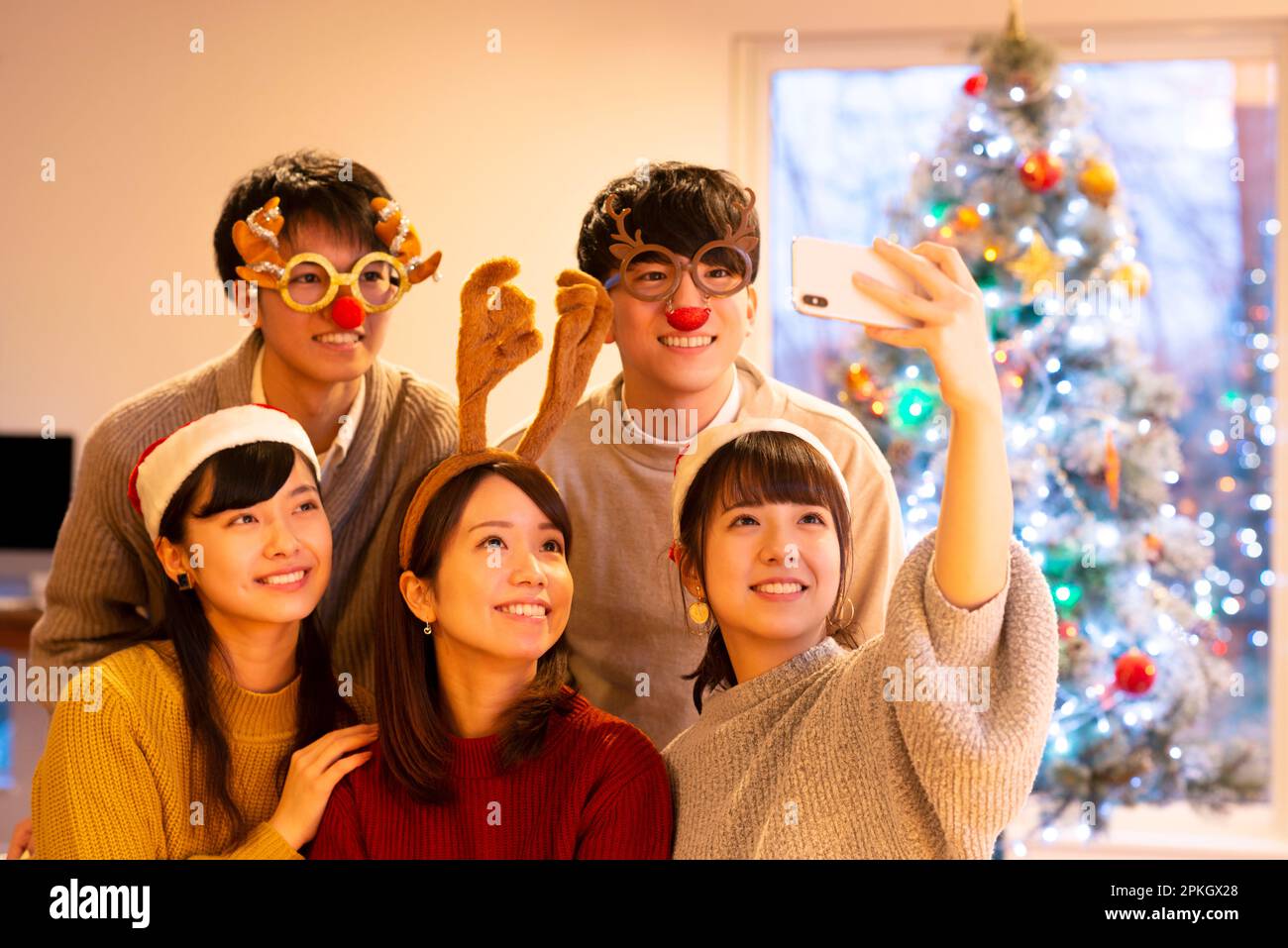 Young people taking a picture at a Christmas party Stock Photo