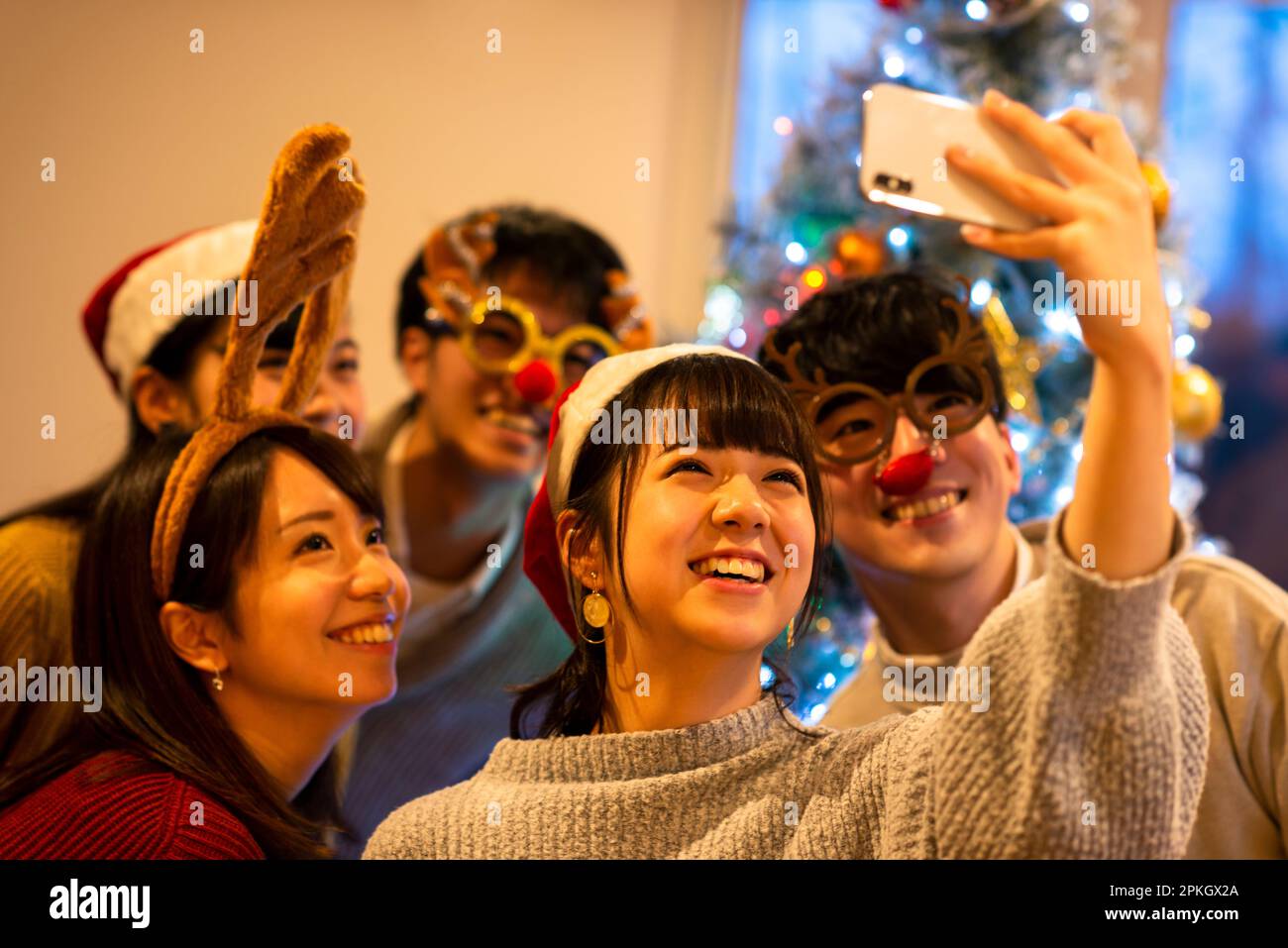 Young people taking a picture at a Christmas party Stock Photo