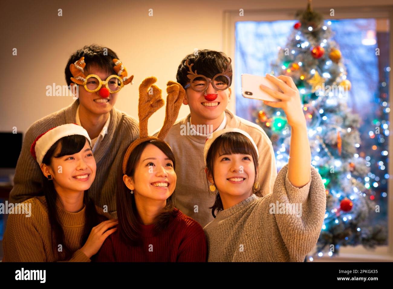Young people taking a picture at a Christmas party Stock Photo