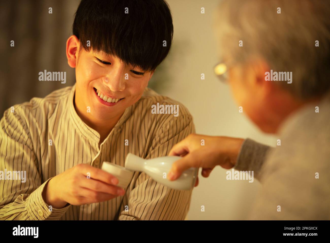 Parents and children drinking sake Stock Photo