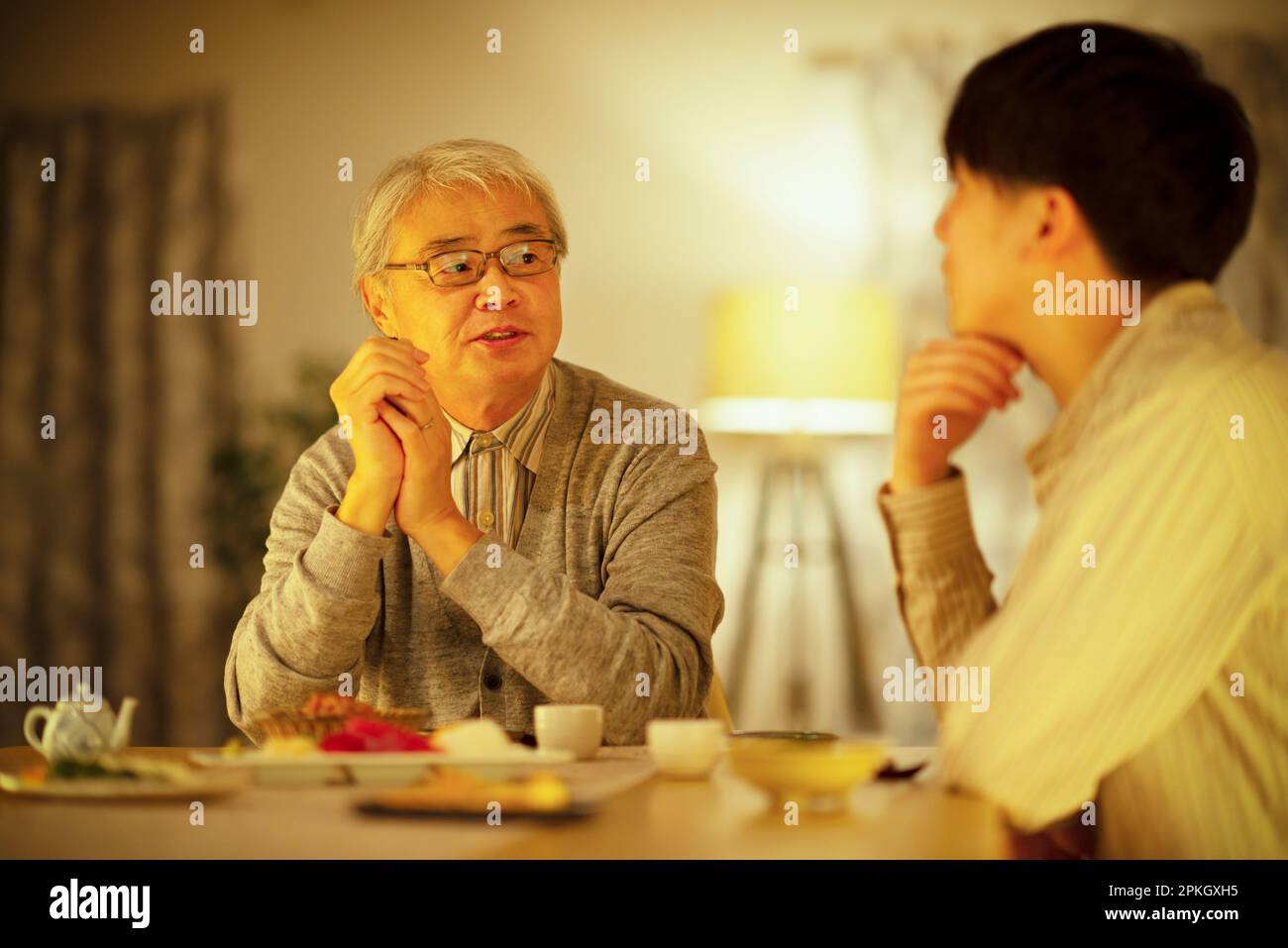 Parents and children drinking sake with dinner Stock Photo