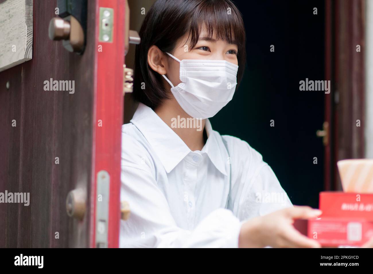 Young woman receiving delivery Stock Photo