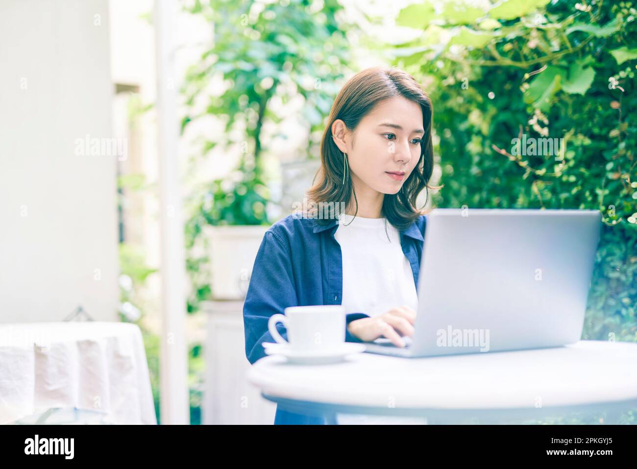 Woman operating laptop computer outdoors Stock Photo