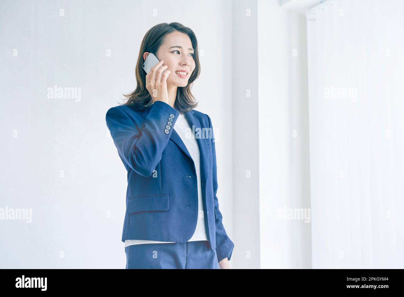 Smiling woman talking on smartphone Stock Photo