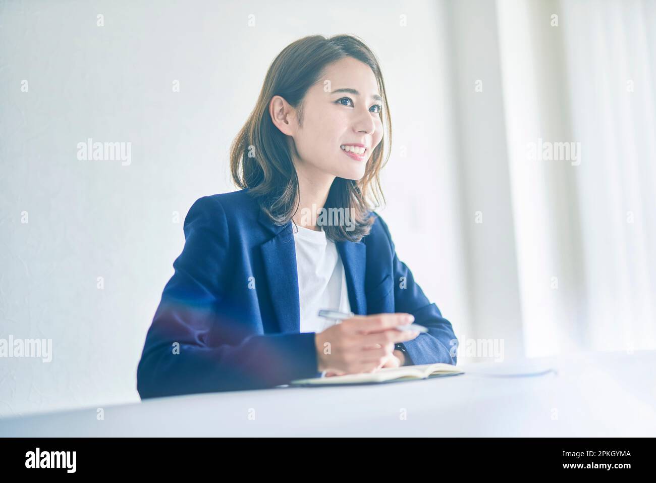 Woman taking notes with a smile Stock Photo