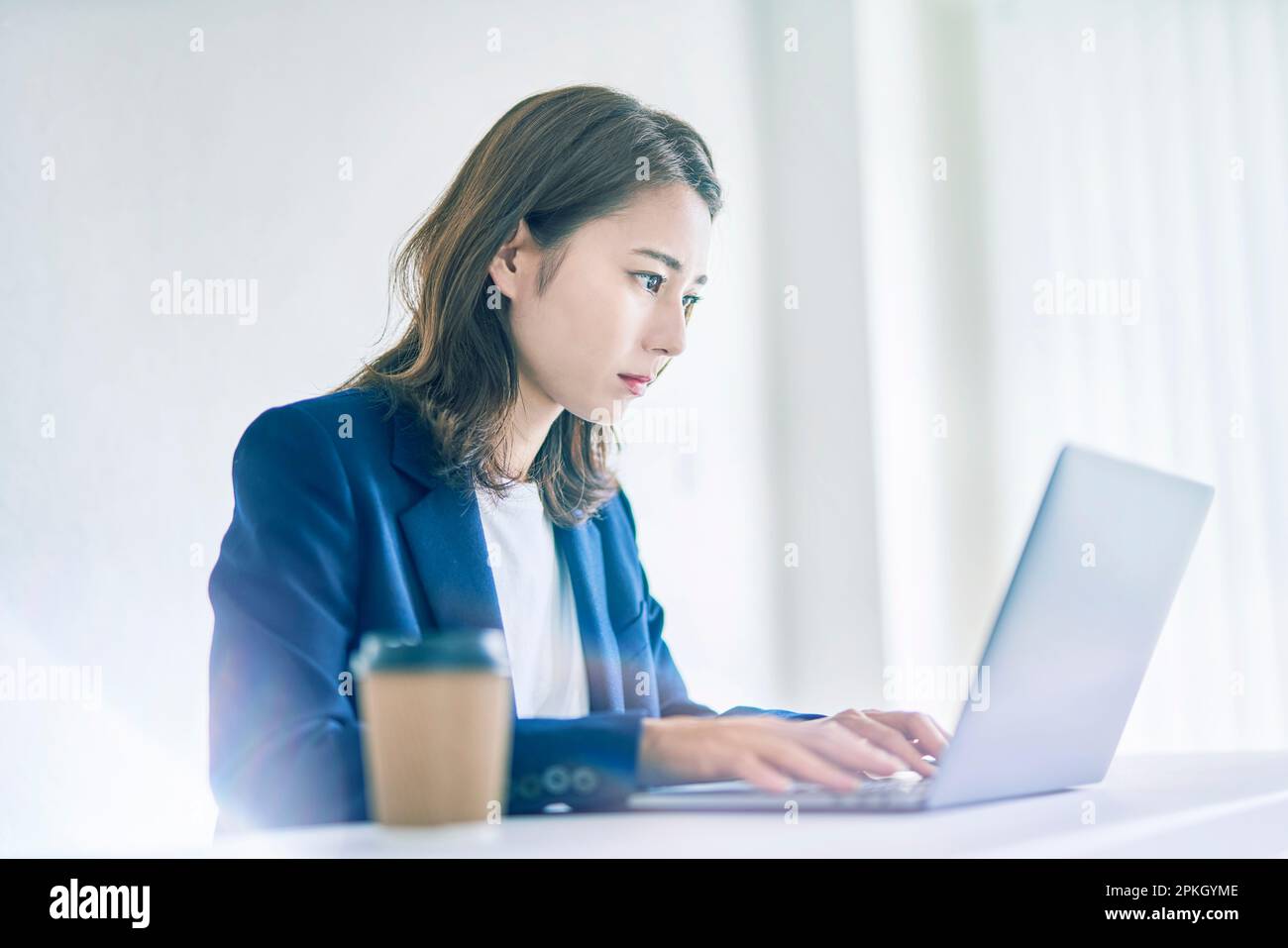 Woman operating a computer Stock Photo