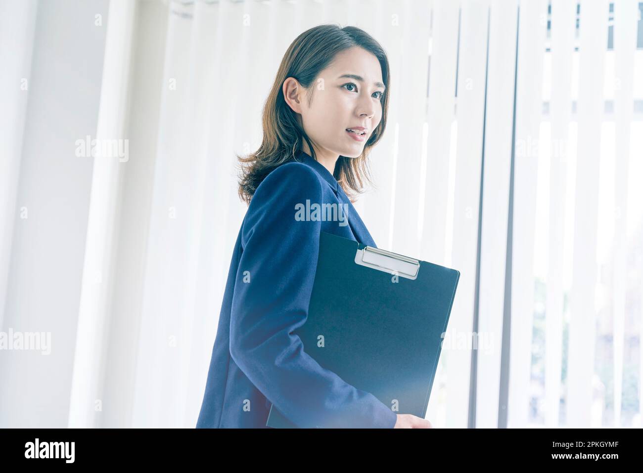 Woman carrying a binder Stock Photo