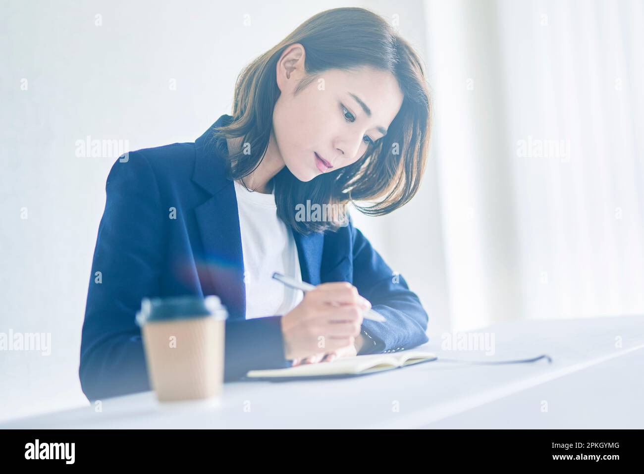 Woman taking notes seriously Stock Photo