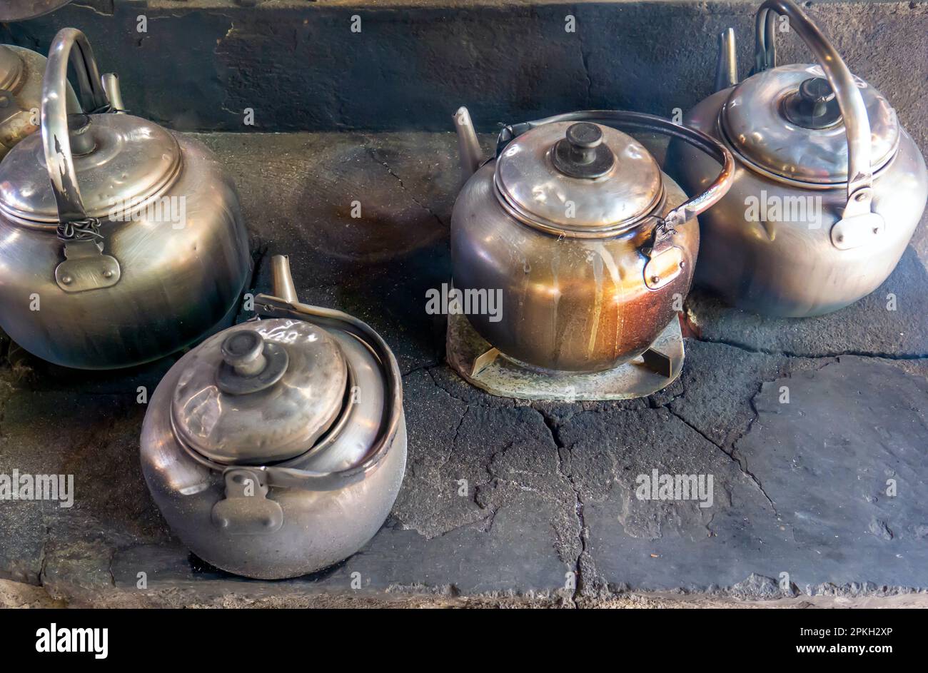 Old and vintage kettles on a traditional wood stove in Yogyakarta