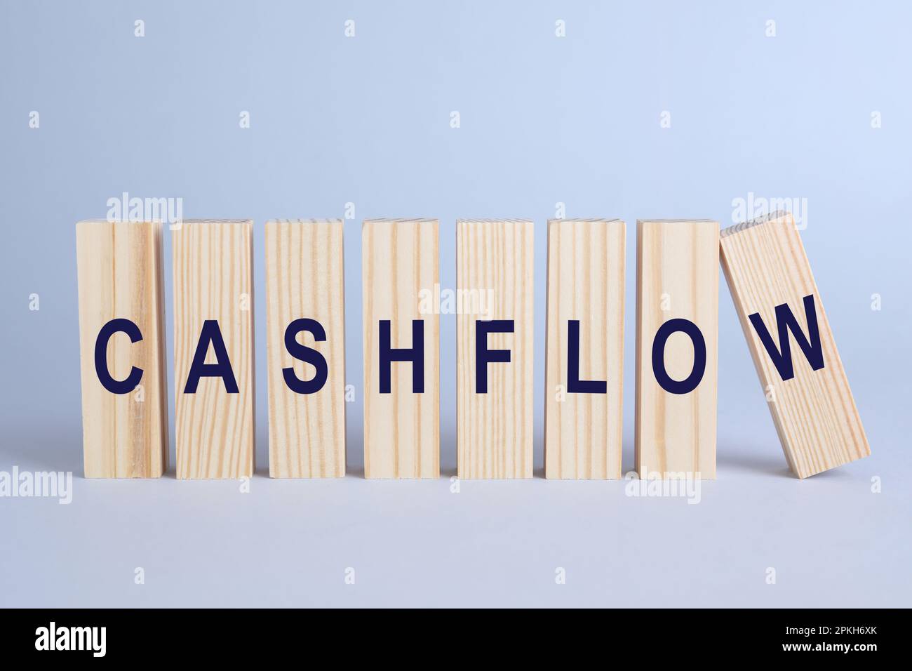 Wooden blocks with phrase Cash FLow on light grey background Stock
