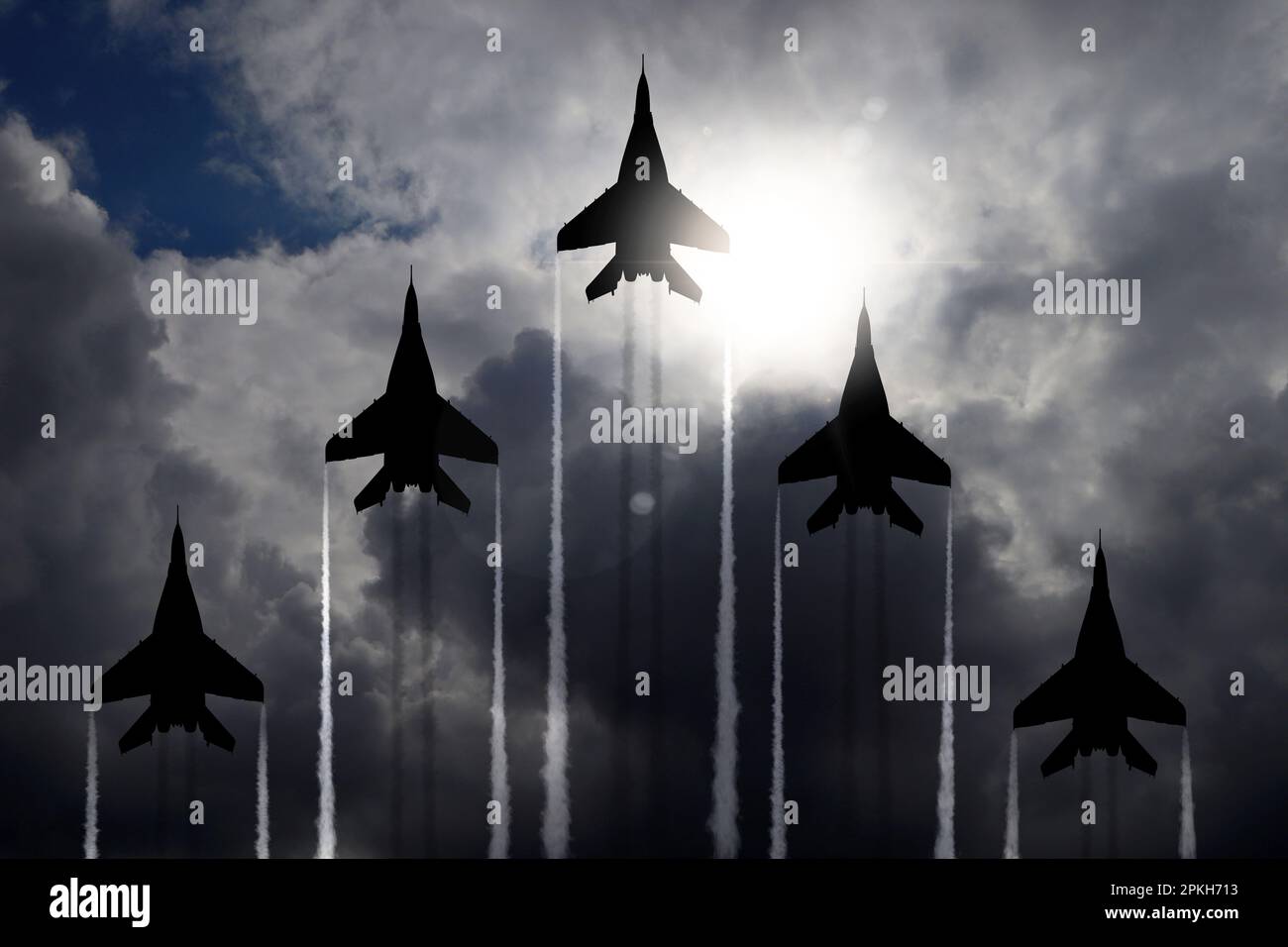 Silhouettes of jet fighters in cloudy sky Stock Photo - Alamy