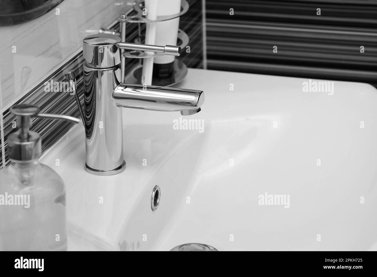 Clean white sink with shiny water tap in bathroom Stock Photo Alamy