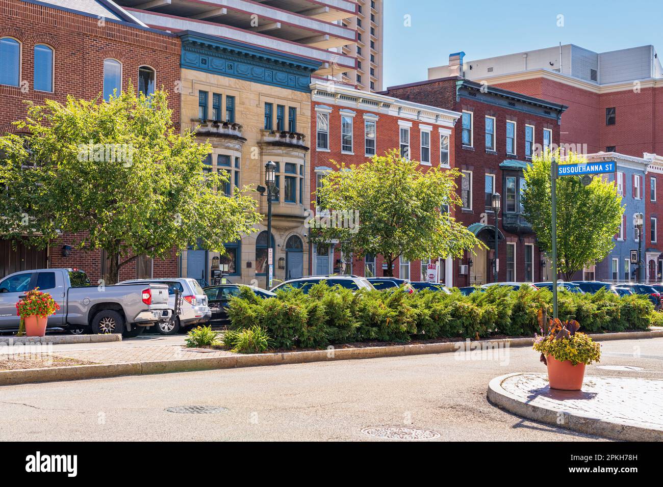 Harrisburg, PA - September 26, 2021 : Modern high rise buildings seen behind traditional brick row houses along State Street in Harrisburg, the capita Stock Photo