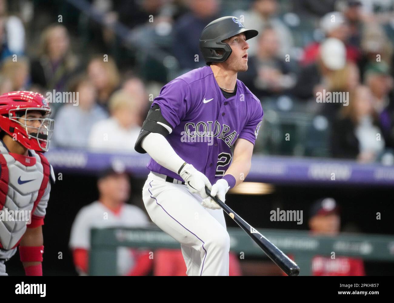 Colorado Rockies' Ryan McMahon, right, follows the flight of his solo