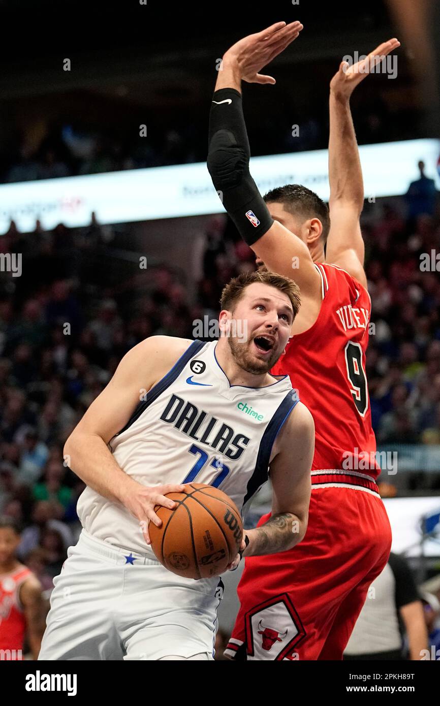 Dallas Mavericks guard Luka Doncic (77) works to the basket against Chicago  Bulls center Nikola Vucevic (9) in the first half of an NBA basketball game  Friday, April 7, 2023, in Dallas. (