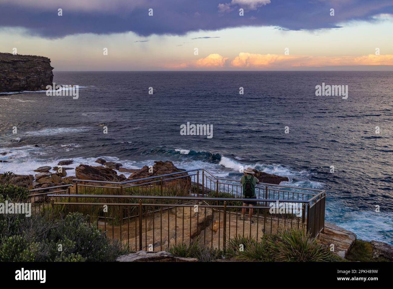 Photographer taking sunset photographs at Providential Point; Wattamolla, Royal National Park Australia Stock Photo