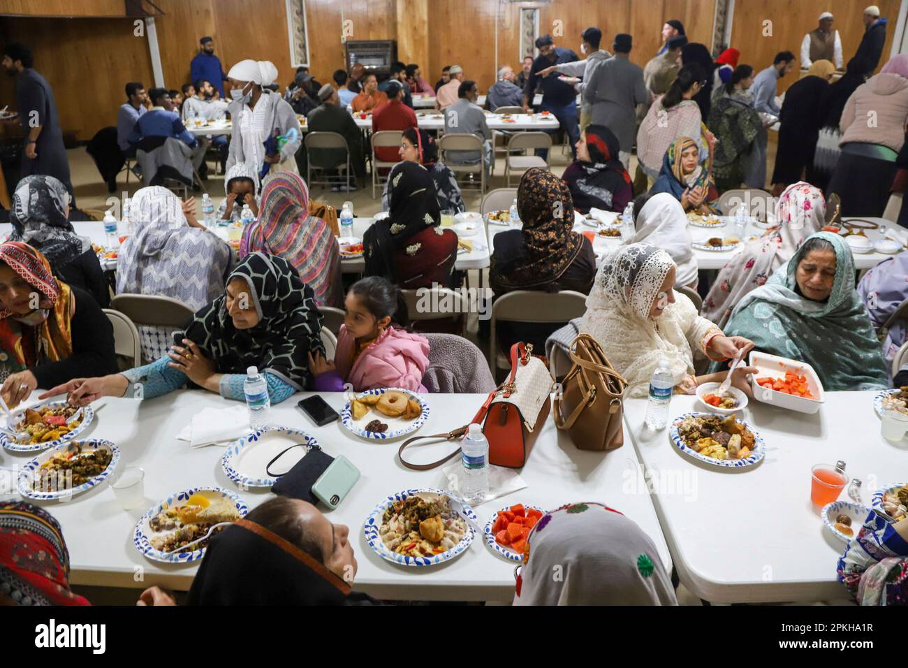 Members gather to break their fast and eat together at sundown during