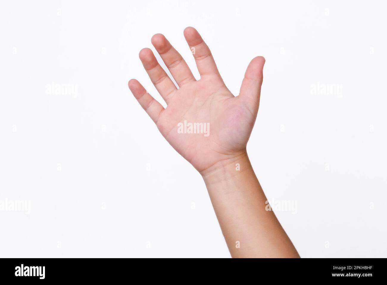 Child hand reaching up ready to help or receive isolated on white background. Helping hand outstretched for salvation. Stock Photo