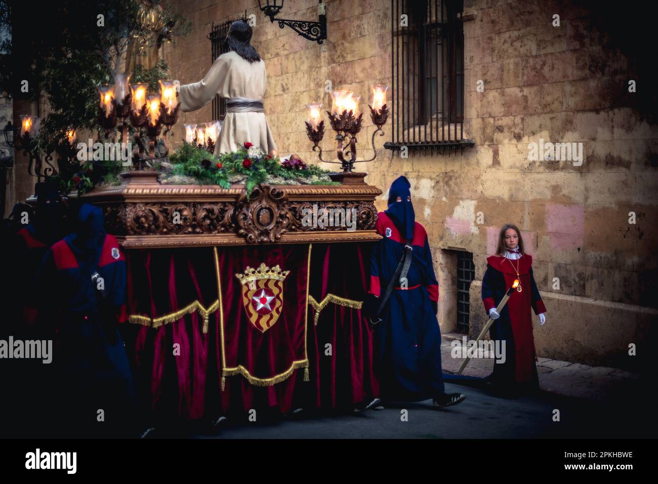 Tarragona, Spain. 7th Apr, 2023. Penitents from the Brotherhood of 'Associaco La Salle' carry a 'paso' (floats that make up the procession) supporting a statue of the Jesus Christ during the Good Friday procession in Tarragona. Credit: Matthias Oesterle/Alamy Live News Stock Photo