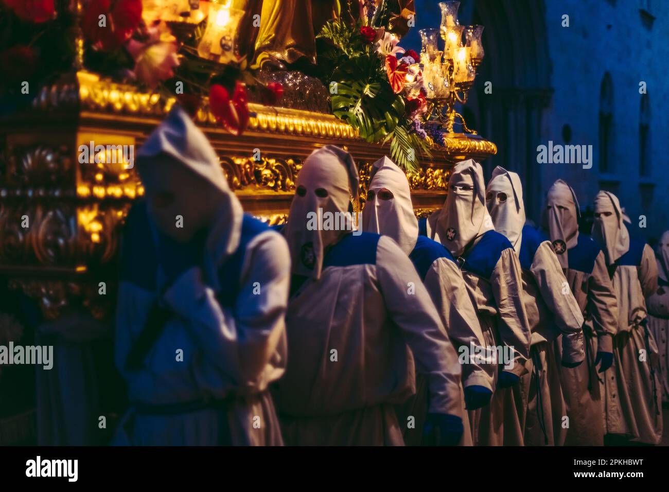 Tarragona, Spain. 7th Apr, 2023. Penitents from the Brotherhood of 'Cofradia Dels Pescadors' carry a 'paso' (floats that make up the procession) supporting a statue of the Jesus Christ during the Good Friday procession in Tarragona. Credit: Matthias Oesterle/Alamy Live News Stock Photo