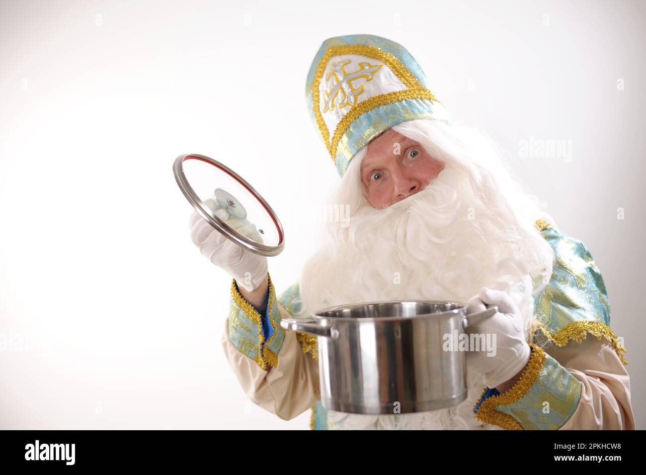 The Father Santa Claus holding a kitchen pan ready for serving or to be delivered take away with special care. Festive culinary preparation background. Happy New Year. High quality photo Stock Photo