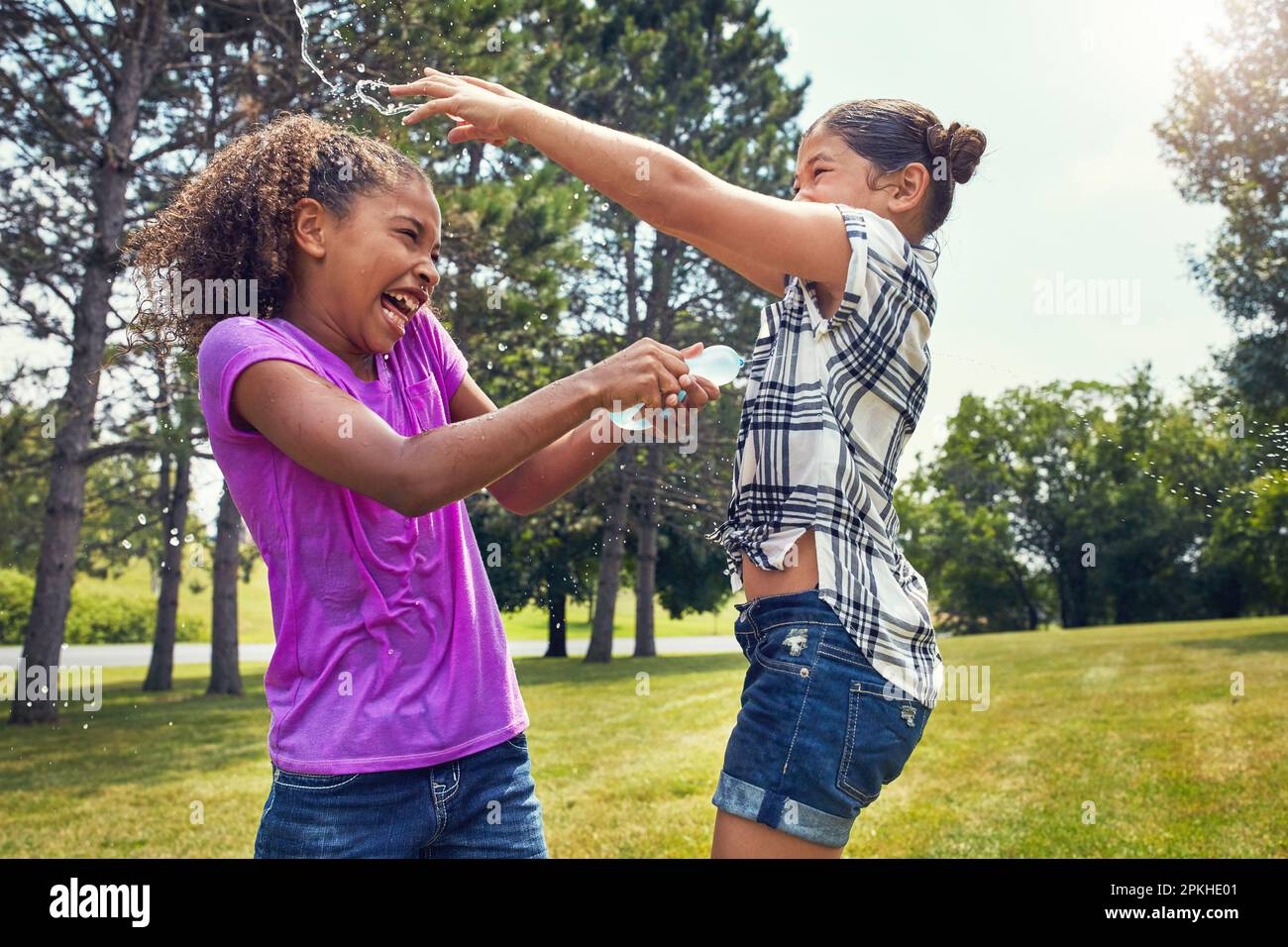 We having a water balloon war. adorable little girls playing with water  balloons outdoors Stock Photo - Alamy