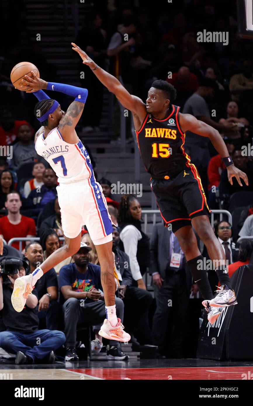 Atlanta Hawks center Clint Capela, right, guards Philadelphia 76ers