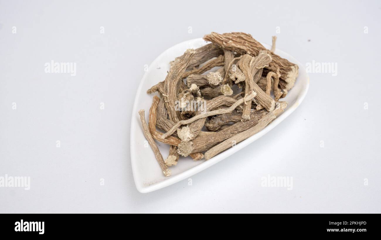 Hog weed, Boerhavia diffusa, dried roots, on white ceramic bowl. Stock Photo