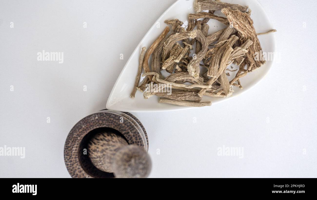 Hog weed, Boerhavia diffusa, dried roots, on white ceramic bowl. Stock Photo