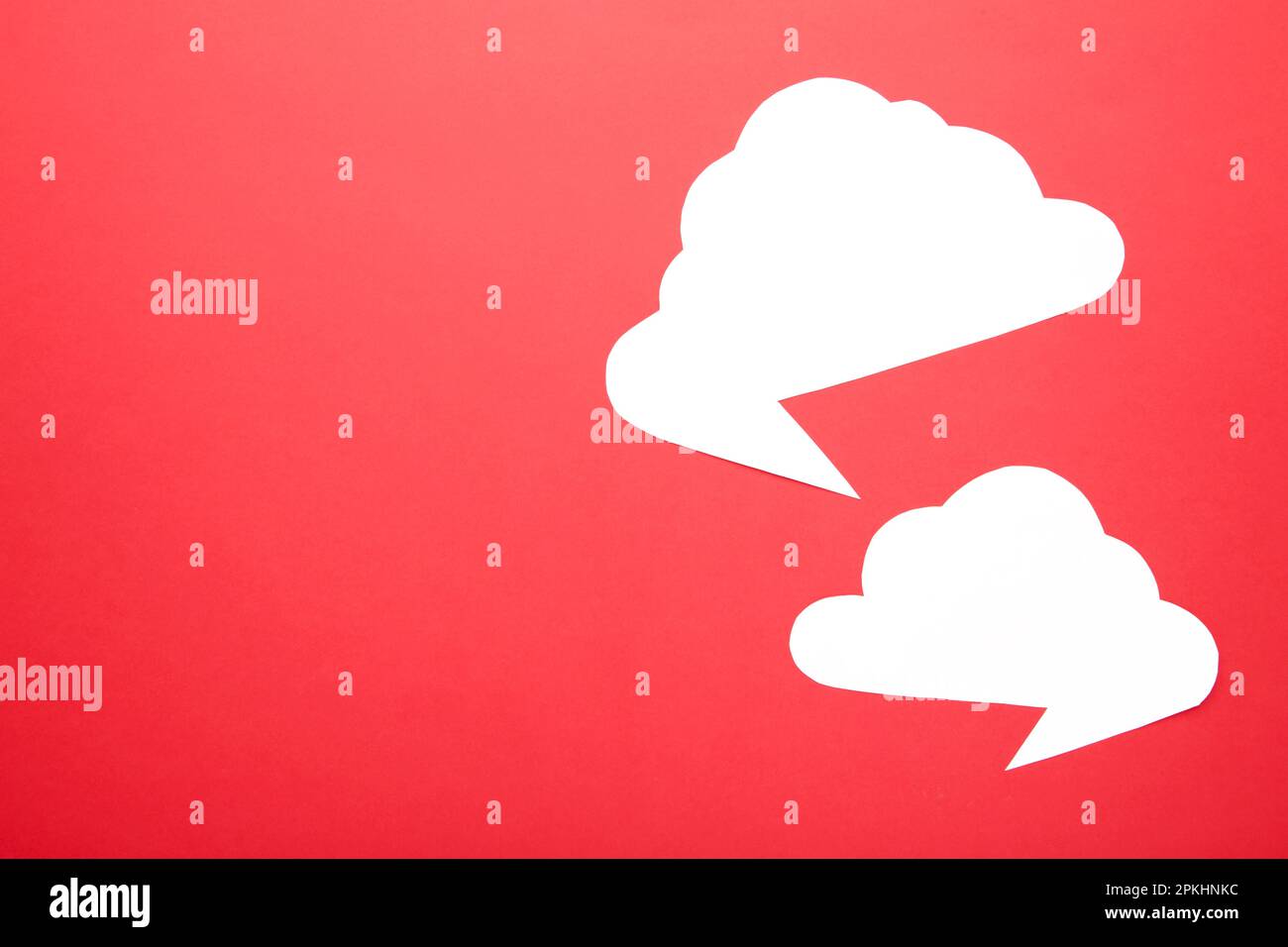 White paper speech bubbles on red background. Top view Stock Photo