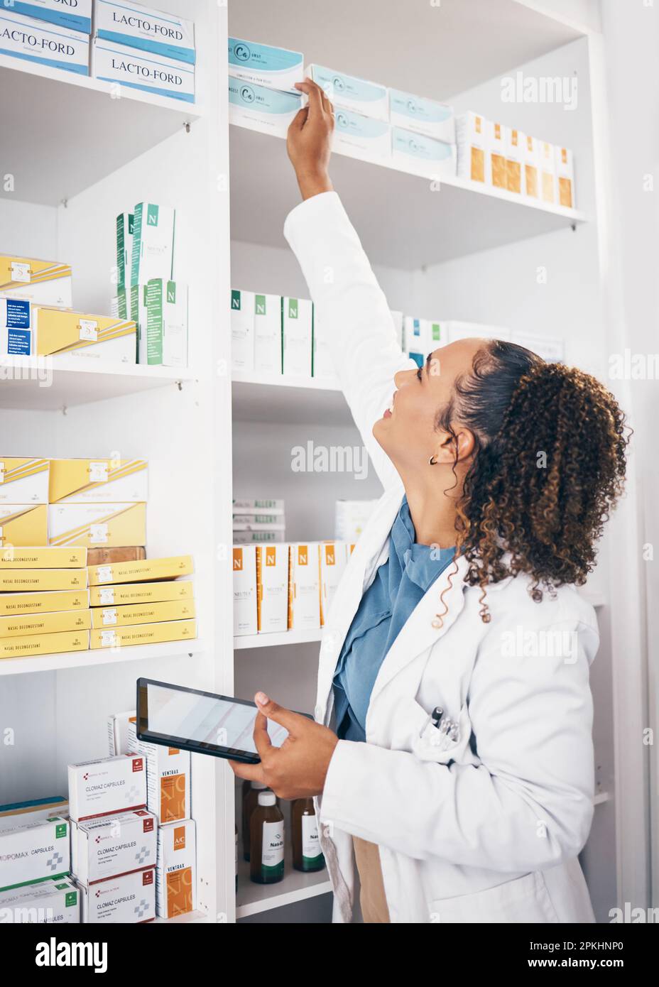 Shelf, pharmacy product and woman with tablet or medicine management, stock research or medical inventory. Digital technology, logistics and medical Stock Photo