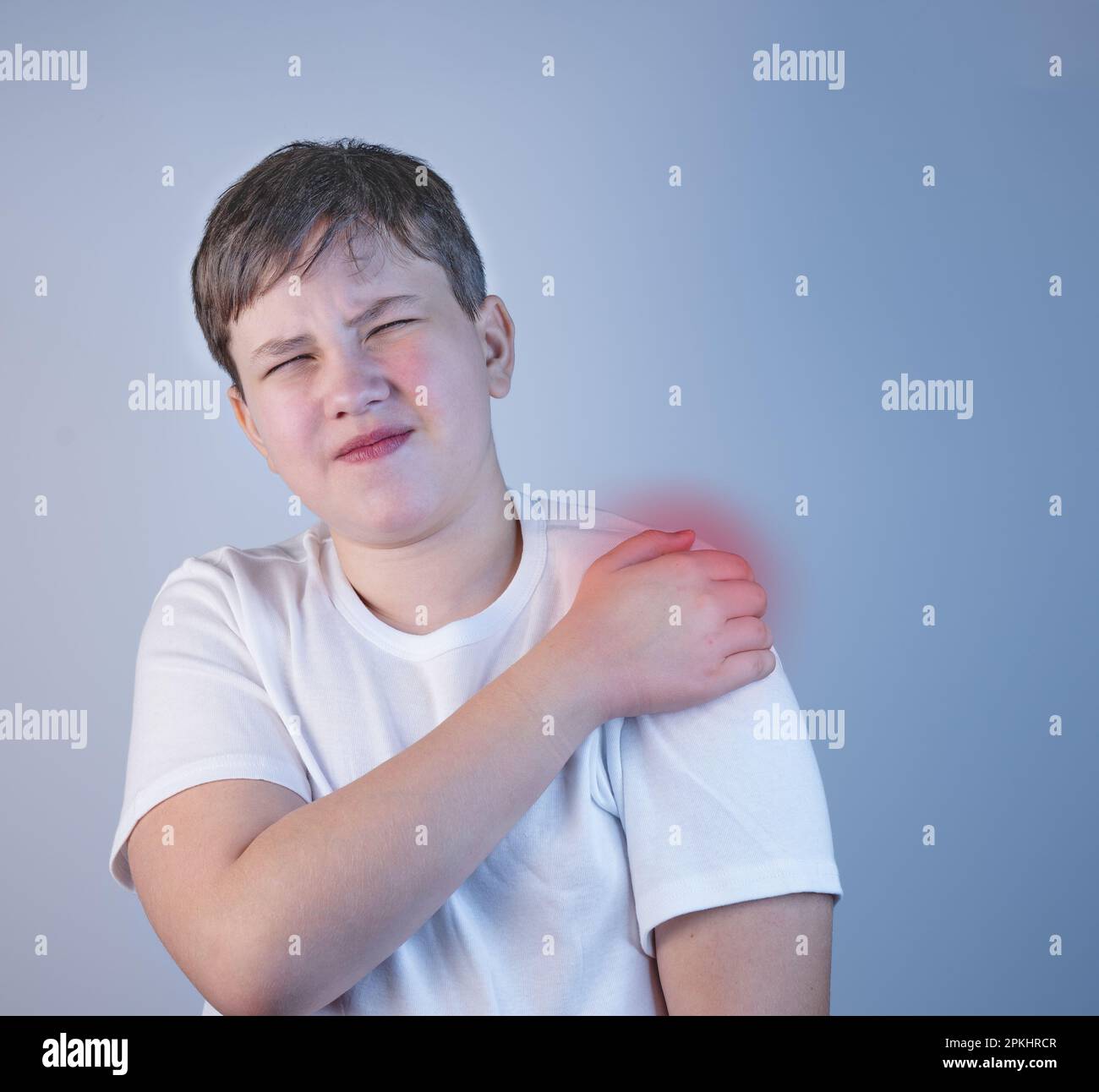 A young man suffering from shoulder pain. Concept disease. Pain in the