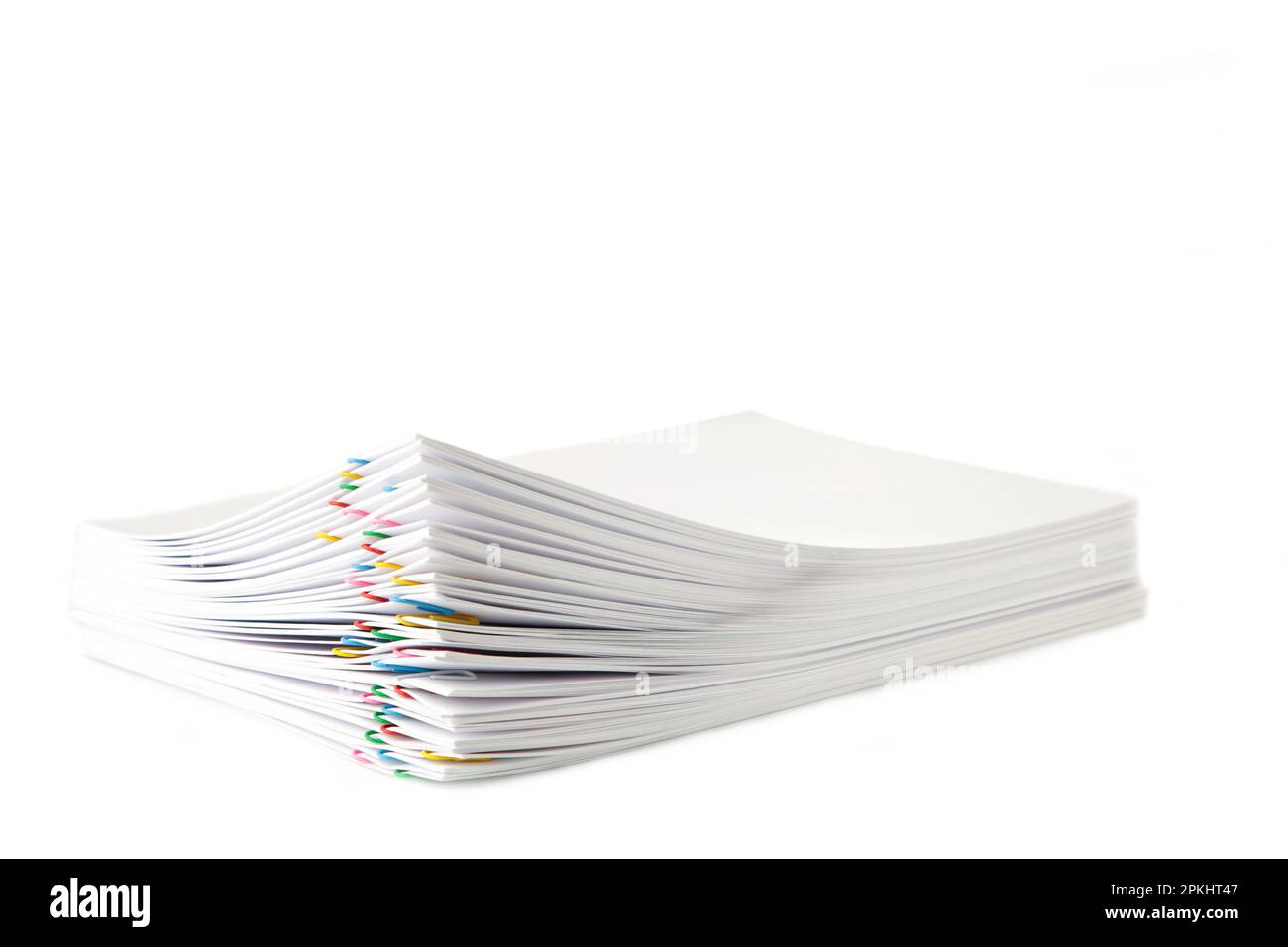 Colorful paper clip with pile of overload white paperwork isolated on ...