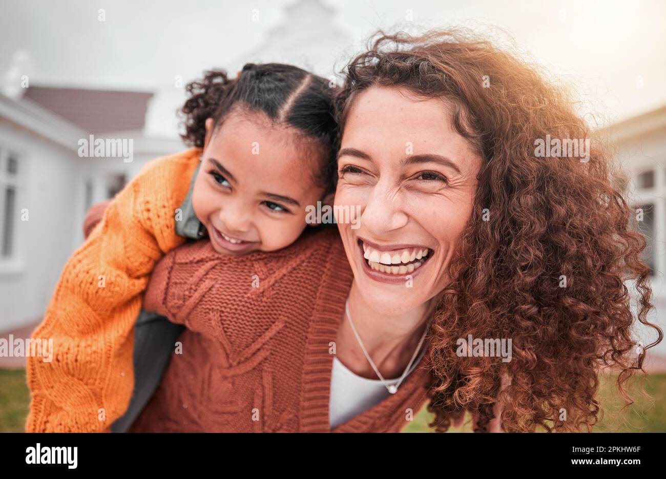 Smile, piggy back and happy woman with child in yard of new house