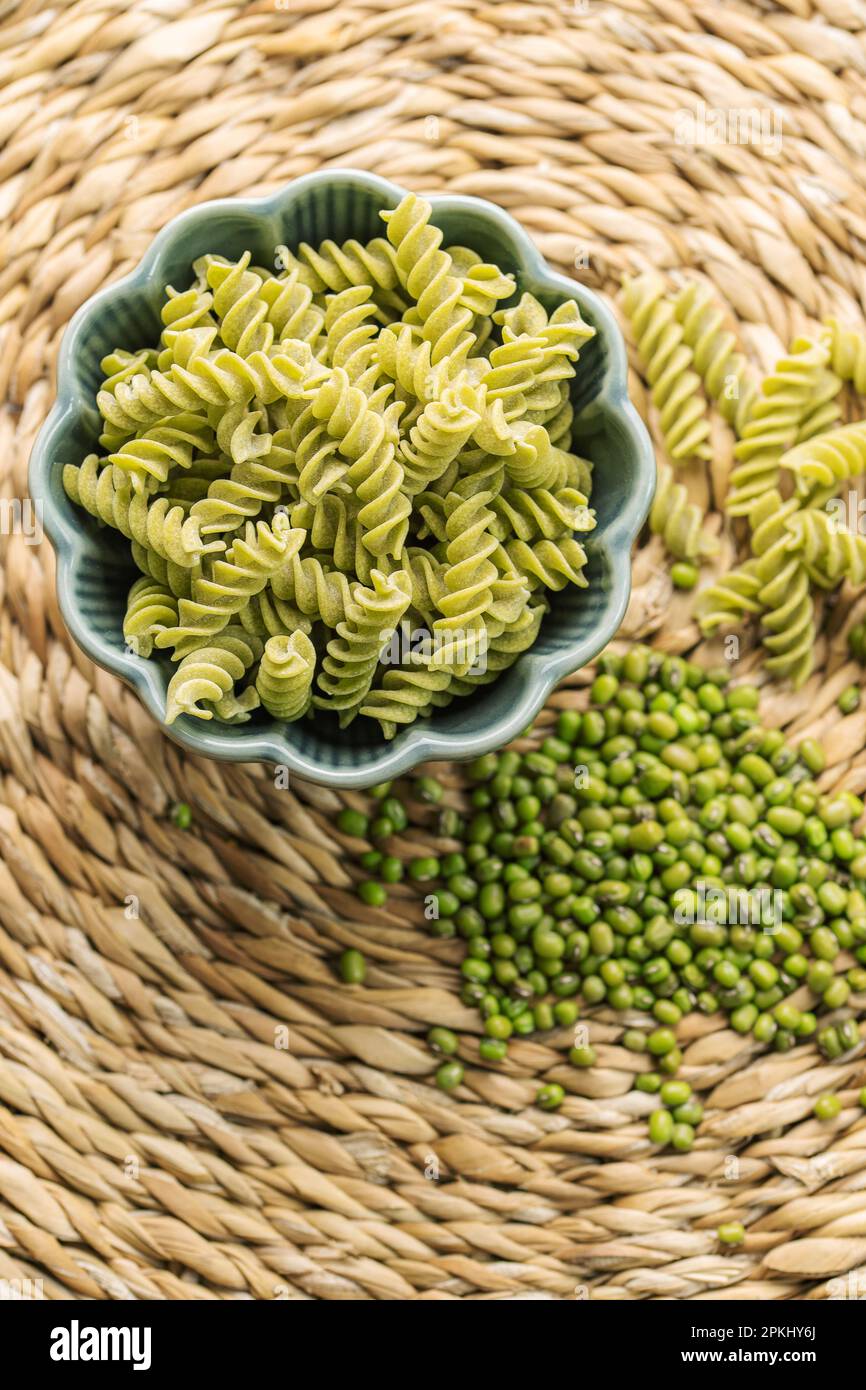 Mung bean fusilli pasta. Bowl with raw pasta and green mung bean