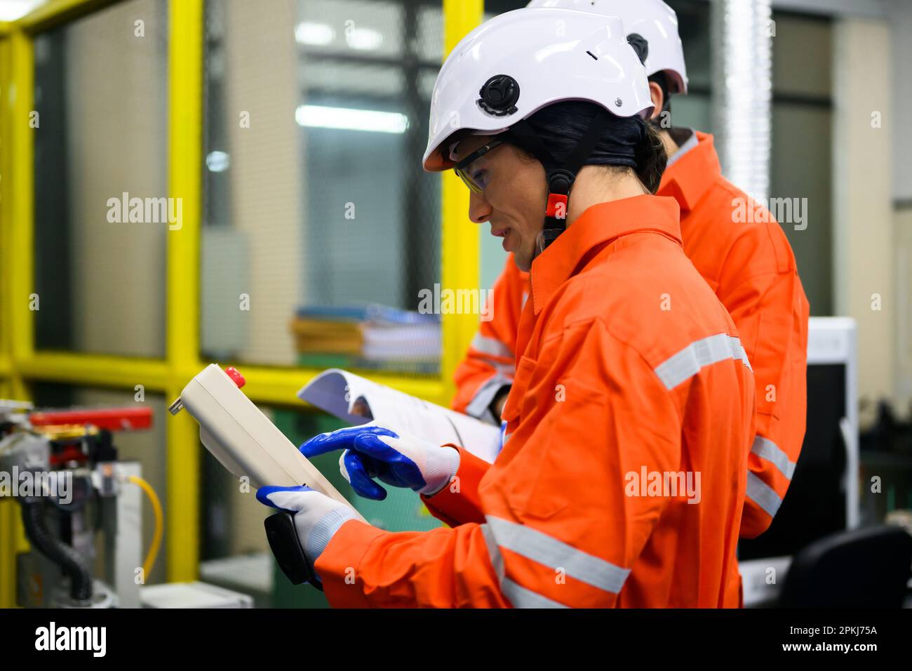 Industrial engineers workers working and checking machine factory Stock Photo