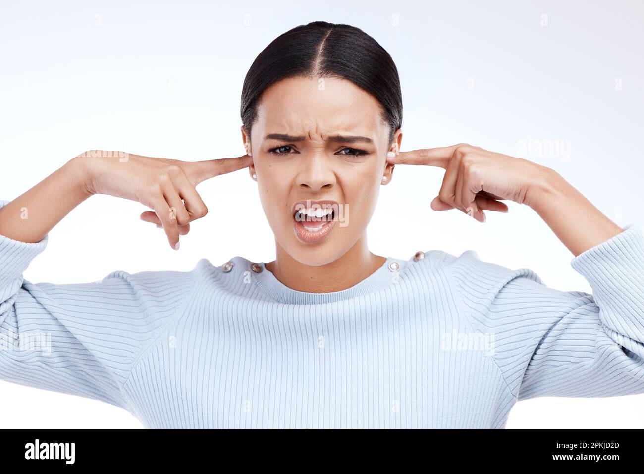 Portrait, woman and finger in ears for noise, silence and denial gesture on  studio white background. Omg, face and angry girl with complaint, ignoring  Stock Photo - Alamy