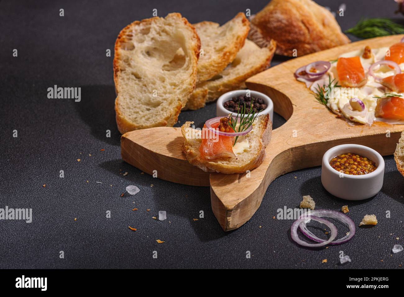 Butter Board food trend topped with salmon, shallots and fresh greens