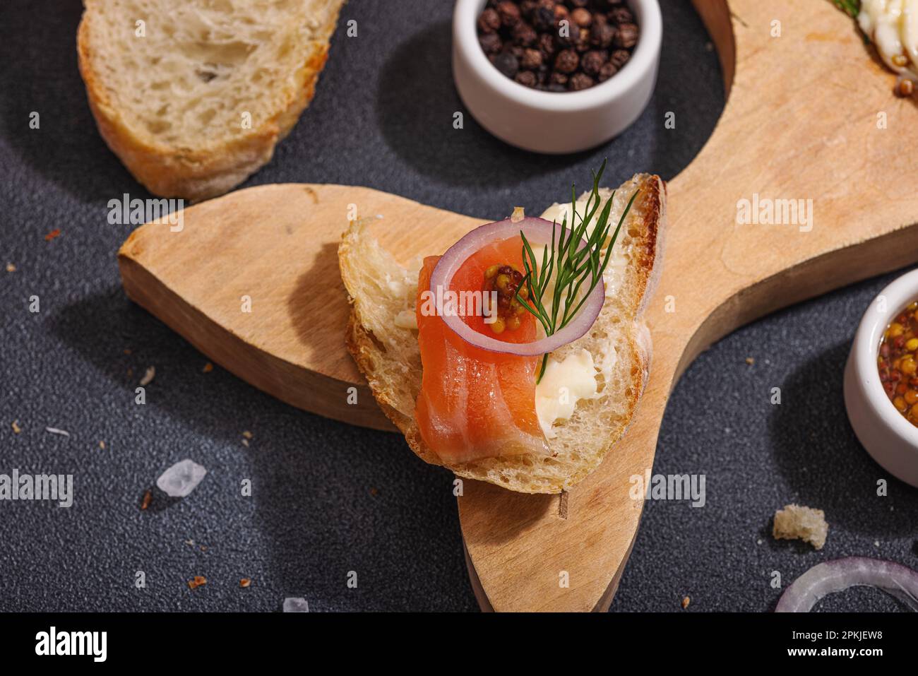 Butter Board food trend topped with salmon, shallots and fresh greens