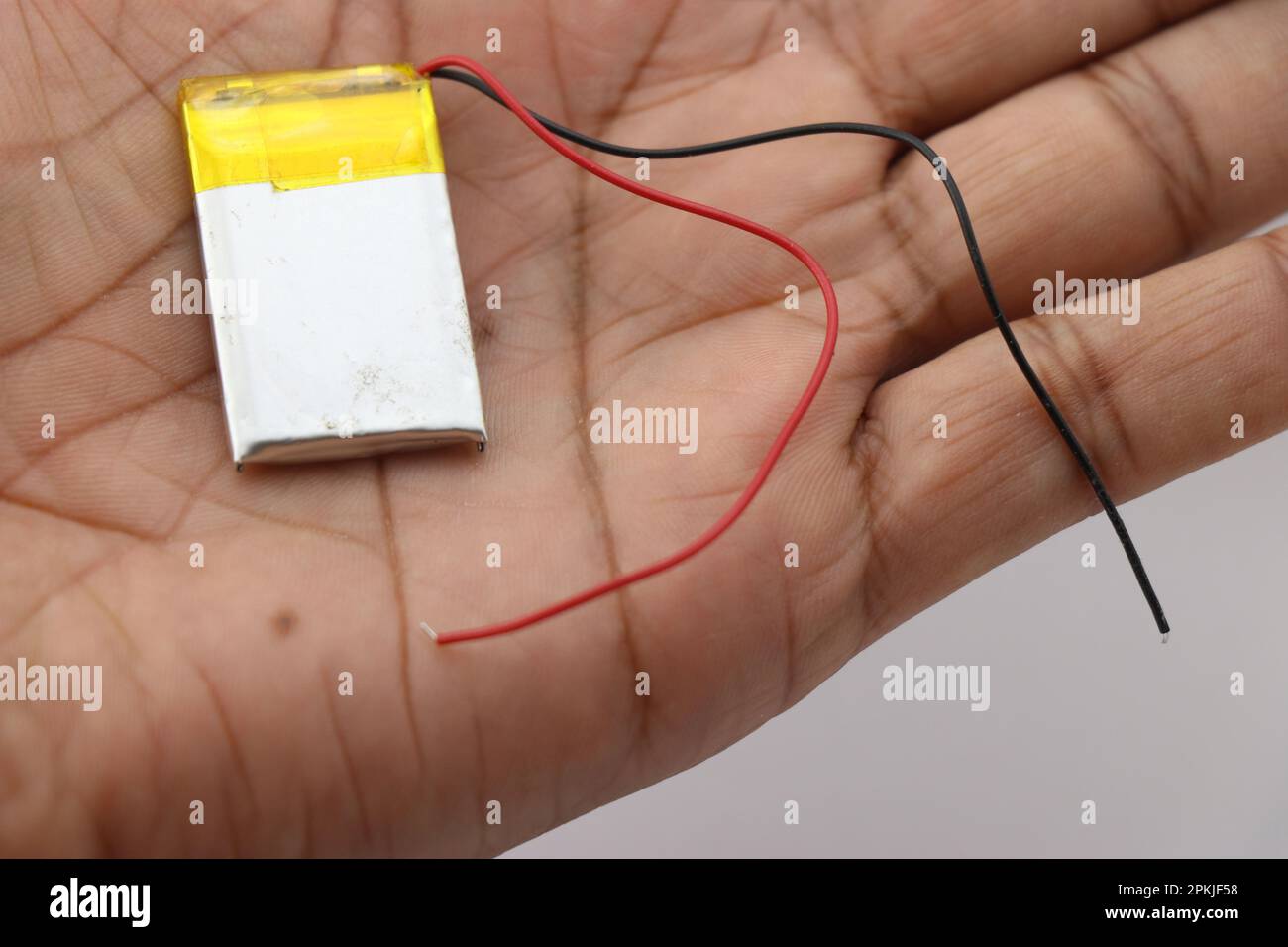 Small lithium polymer battery with wires for connection held in the