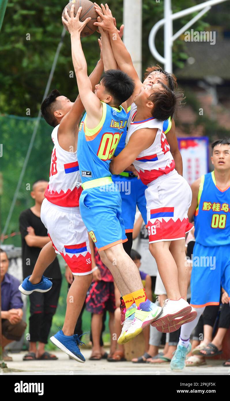 (230408) -- NANNING, April 8, 2023 (Xinhua) -- Villagers play basketball to celebrate the Xinhe Festival in Wuying village of Rongshui Miao Autonomous Prefecture, south China's Guangxi Zhuang Autonomous Region, July 19, 2019. Basketball has long been popular in Wuying Village. In the past, the villagers played on a dirt court. The local government has been upgrading the infrastruture in recent years, including building a new basketball court of concrete. Now the sport becomes even more popular among the villagers, especially the kids. The village organizes basketball matches to celebrate festi Stock Photo