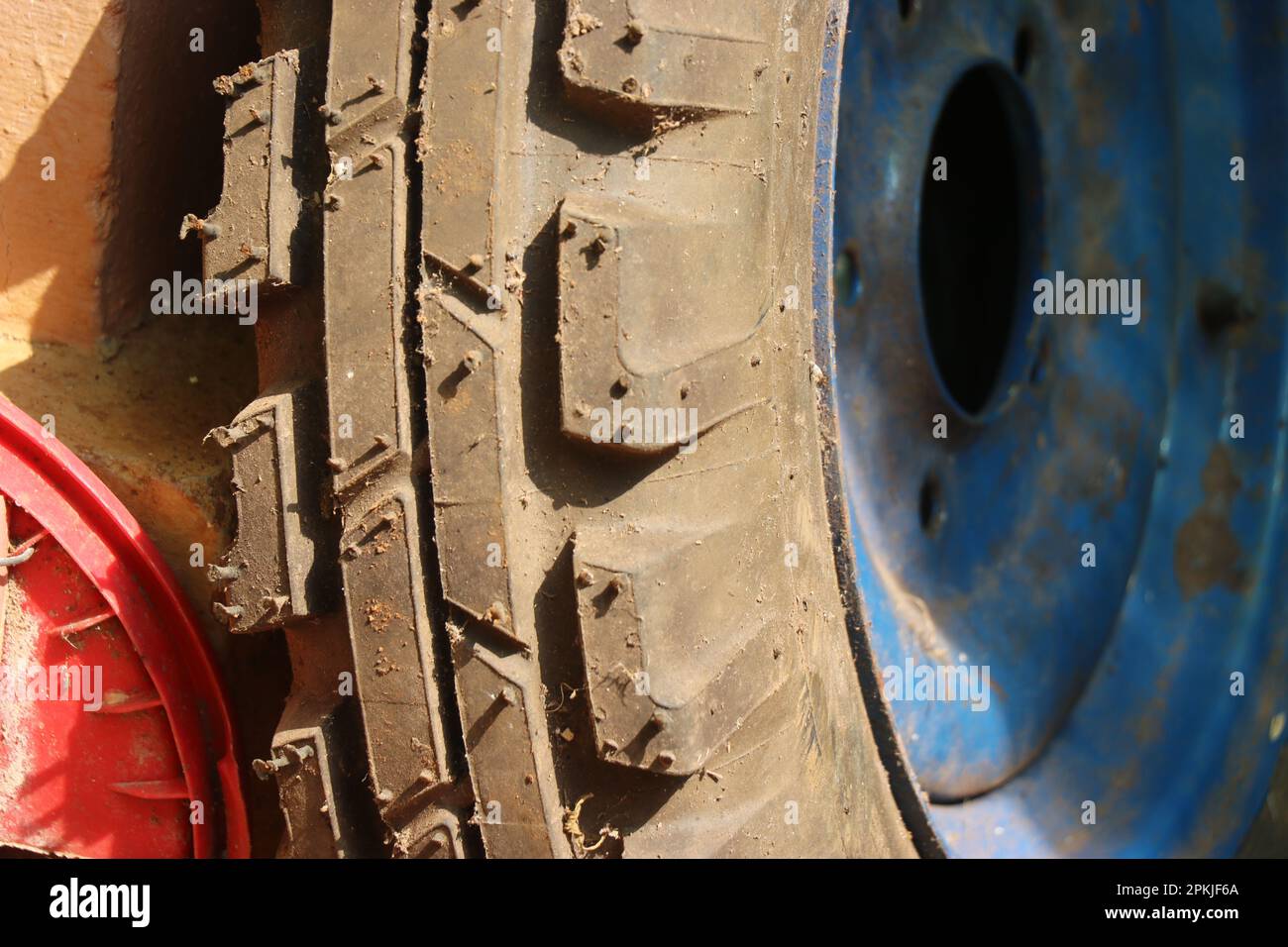 Close-up of a gripper from the front wheel of a tractor. Replacing tractor tires Stock Photo