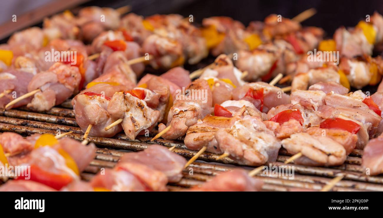 banner of delicious meat and vegetable skewers cooking on coals Stock Photo