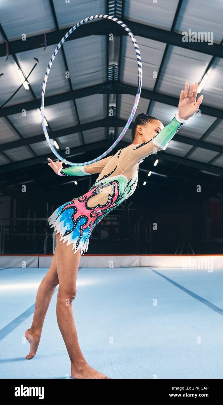 Woman, gymnastics and hoop for performance, sports training and dancing  action in arena. Female, rhythmic movement and dancer with spinning ring  for Stock Photo - Alamy