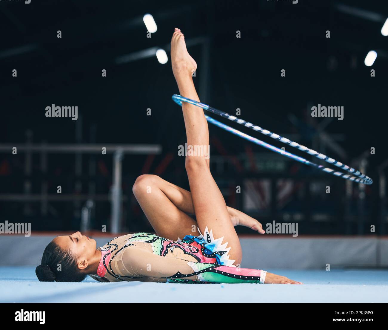 Woman, gymnastics and spinning hoop on leg for competition, sports