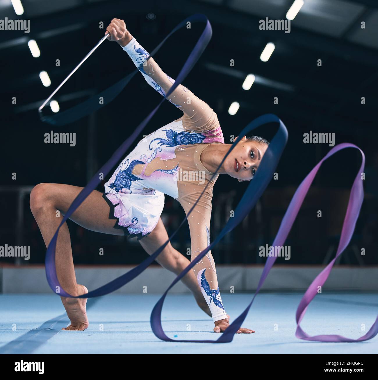 Portrait of flexible woman, ribbon gymnastics and dance for performance