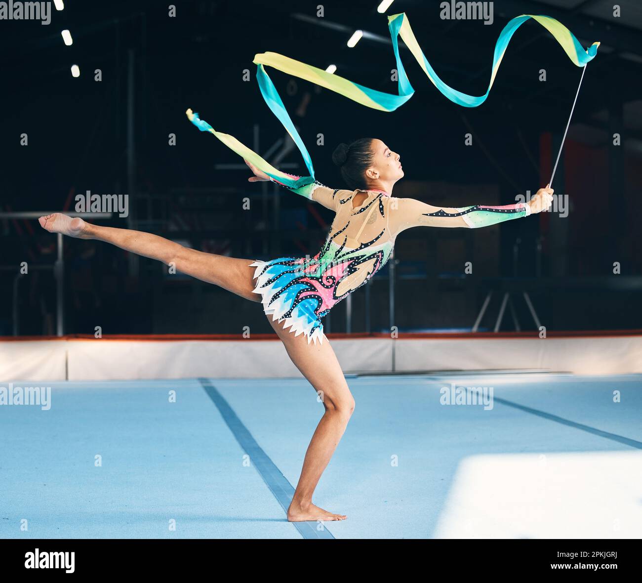 Ribbon, gymnastics and flexible woman stretching in performance, dancer