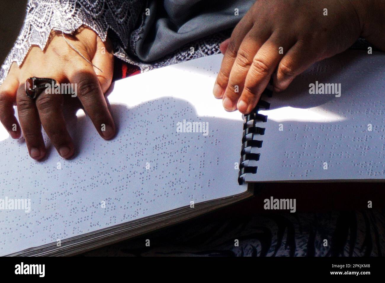 Surabaya, Indonesia. 8th Apr, 2023. A visually impaired person reads a