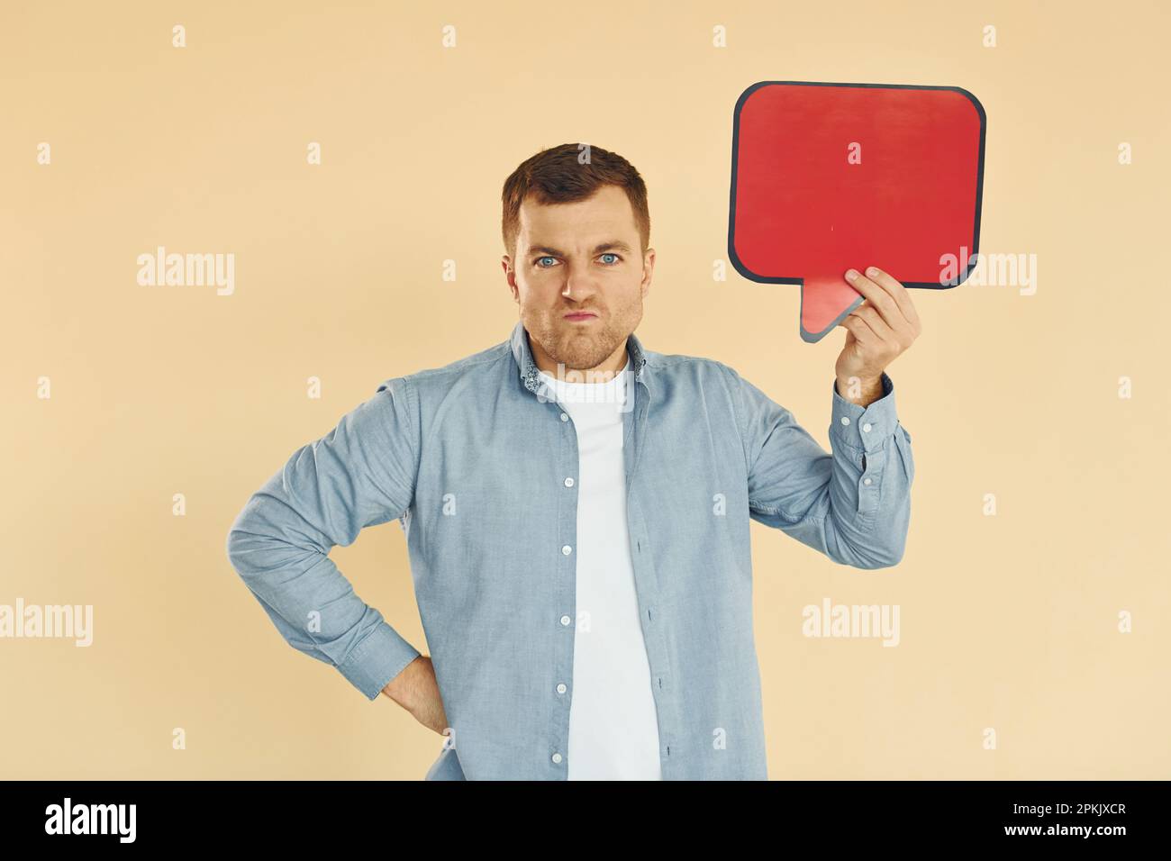 Facial expression. Man standing in the studio with empty signs for the ...