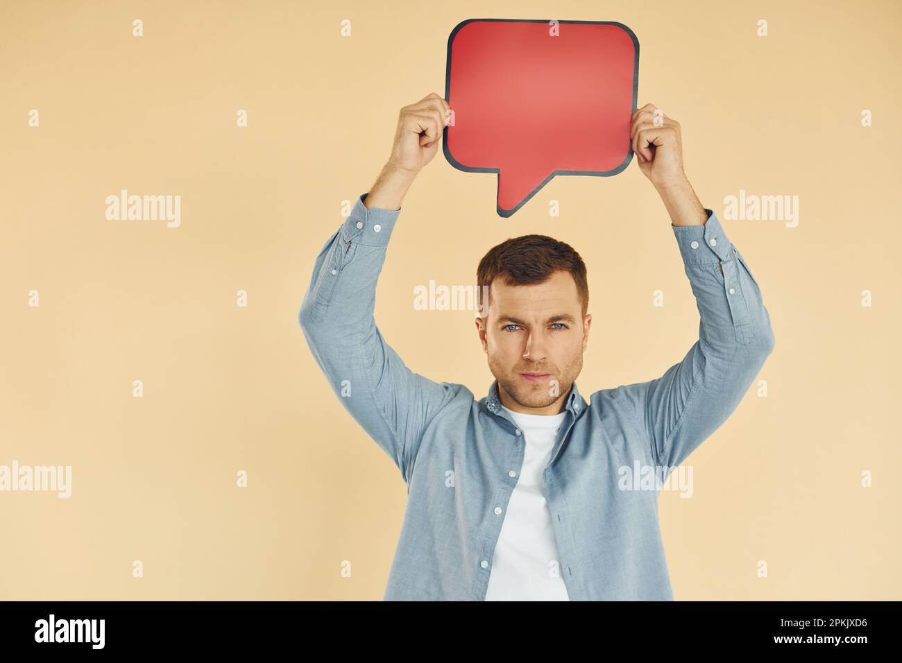Facial expression. Man standing in the studio with empty signs for the ...